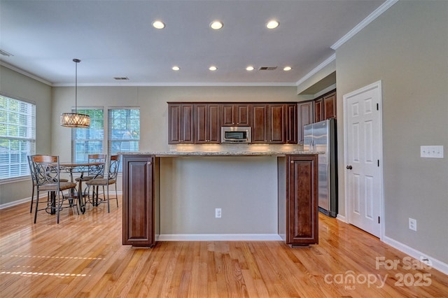 kitchen featuring dark brown cabinetry, light wood-type flooring, crown molding, visible vents, and appliances with stainless steel finishes