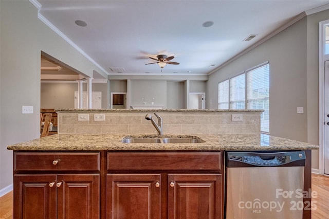 kitchen with a sink, stainless steel dishwasher, and crown molding