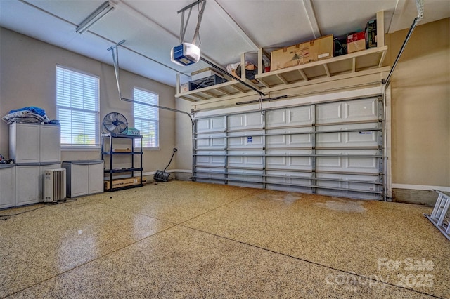 garage with a garage door opener and baseboards