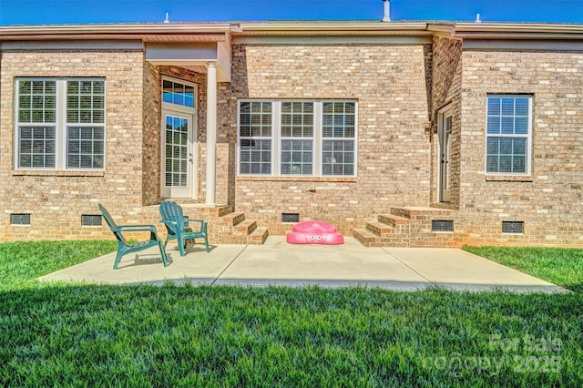 back of property featuring brick siding, a yard, and crawl space
