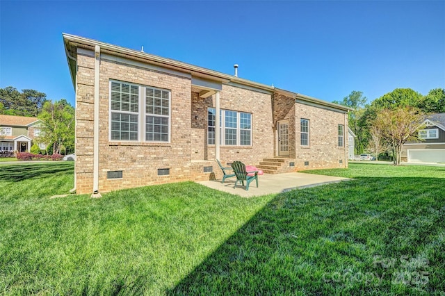 rear view of house featuring a patio area, a lawn, and crawl space