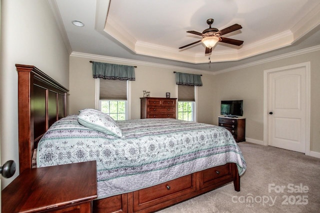 bedroom featuring ornamental molding, light colored carpet, and a raised ceiling