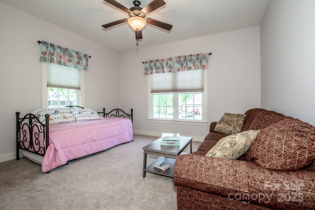 carpeted bedroom featuring ceiling fan and baseboards