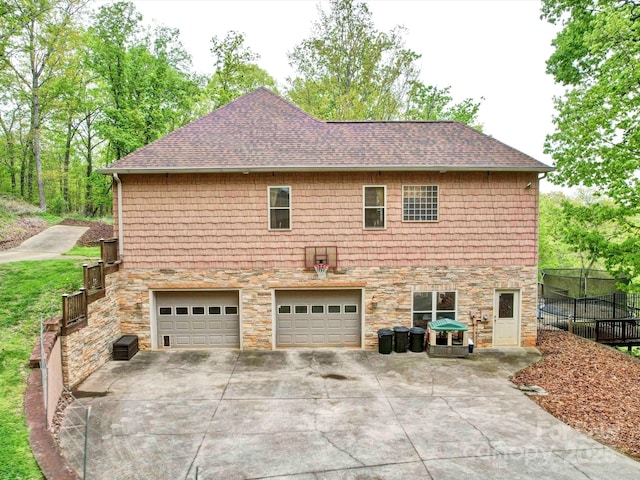 135 Boulder Ridge Dr, Denton, NC 27239 - view of home's exterior with concrete driveway, roof with shingles, stone siding, and an attached garage