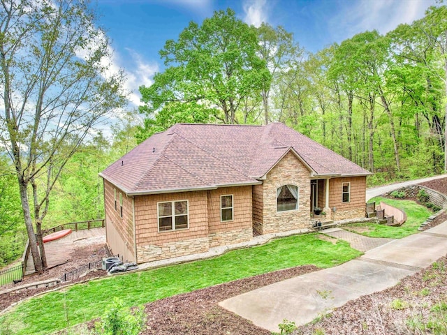 135 Boulder Ridge Dr, Denton, NC 27239 - ranch-style home with a front yard, roof with shingles, stone siding, and fence