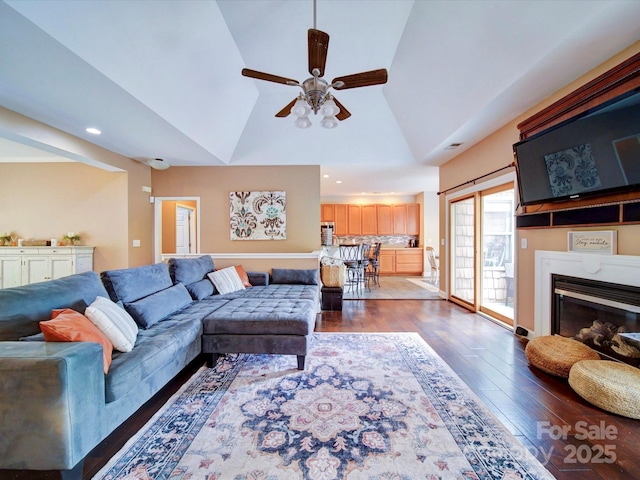 135 Boulder Ridge Dr, Denton, NC 27239 - living room with a glass covered fireplace, dark wood-style flooring, vaulted ceiling, recessed lighting, and ceiling fan