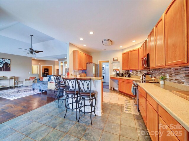135 Boulder Ridge Dr, Denton, NC 27239 - kitchen featuring a ceiling fan, a kitchen bar, recessed lighting, stainless steel appliances, and decorative backsplash