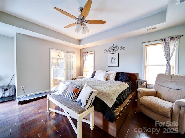 135 Boulder Ridge Dr, Denton, NC 27239 - bedroom featuring dark wood-style floors, visible vents, multiple windows, and a raised ceiling