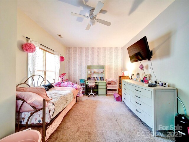 135 Boulder Ridge Dr, Denton, NC 27239 - bedroom with light colored carpet, an accent wall, a ceiling fan, visible vents, and wallpapered walls