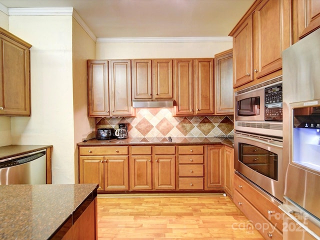 135 Boulder Ridge Dr, Denton, NC 27239 - kitchen with light wood-style flooring, under cabinet range hood, decorative backsplash, and stainless steel appliances