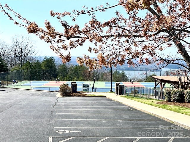 135 Boulder Ridge Dr, Denton, NC 27239 - uncovered parking lot featuring a tennis court and fence