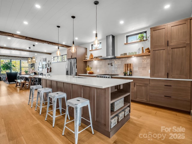 408 S Oconeechee Ave, Black Mountain, NC 28711 - kitchen featuring stainless steel fridge with ice dispenser, open shelves, light wood finished floors, and wall chimney exhaust hood