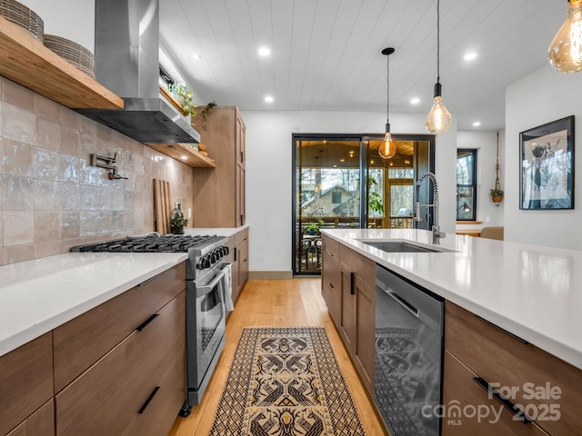 408 S Oconeechee Ave, Black Mountain, NC 28711 - kitchen featuring recessed lighting, wall chimney exhaust hood, a sink, light wood-style flooring, and stainless steel appliances