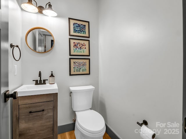 408 S Oconeechee Ave, Black Mountain, NC 28711 - bathroom featuring toilet, baseboards, wood finished floors, and vanity