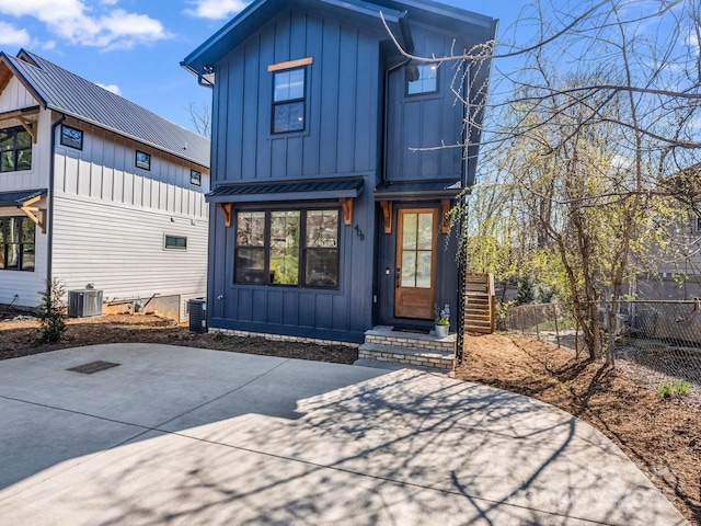 408 S Oconeechee Ave, Black Mountain, NC 28711 - view of front of home featuring board and batten siding, central AC, metal roof, and fence