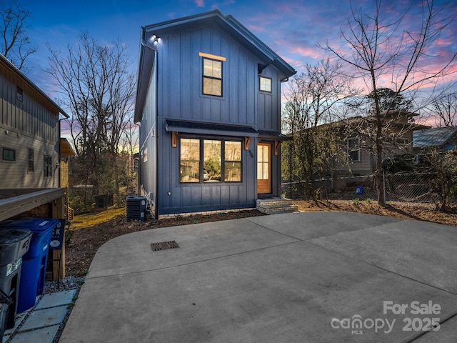 408 S Oconeechee Ave, Black Mountain, NC 28711 - back of property at dusk with fence, board and batten siding, and central AC