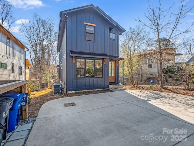 408 S Oconeechee Ave, Black Mountain, NC 28711 - back of house featuring board and batten siding, central air condition unit, a standing seam roof, and fence