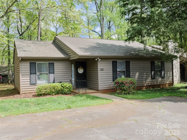 ranch-style house with a shingled roof