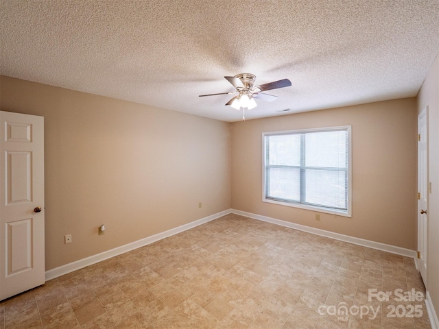 unfurnished room featuring baseboards, visible vents, ceiling fan, and a textured ceiling
