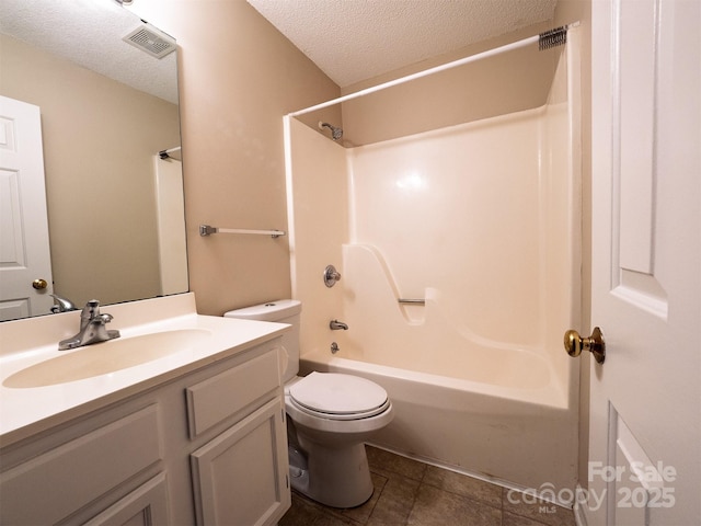 bathroom with tile patterned floors, toilet, shower / bathtub combination, vanity, and a textured ceiling