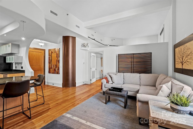 84 Walnut St Unit 203, Asheville, NC 28801 - living area with arched walkways, visible vents, light wood finished floors, and beam ceiling