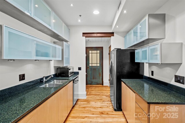 84 Walnut St Unit 203, Asheville, NC 28801 - kitchen featuring visible vents, a sink, light wood-type flooring, glass insert cabinets, and appliances with stainless steel finishes