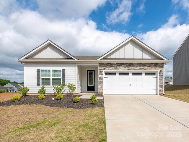 craftsman-style home with a garage, board and batten siding, driveway, and a front lawn