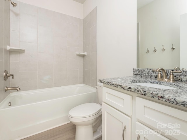 bathroom with shower / bath combination, wood finished floors, toilet, and vanity