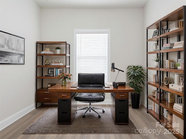 office area featuring baseboards and wood finished floors
