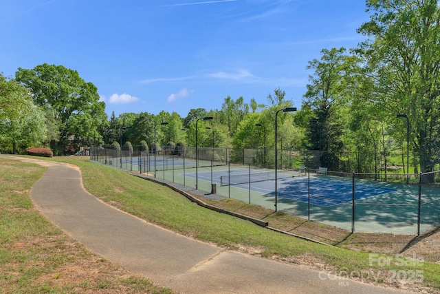 view of sport court featuring fence
