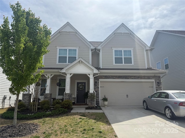 craftsman inspired home featuring an attached garage, covered porch, stone siding, and concrete driveway