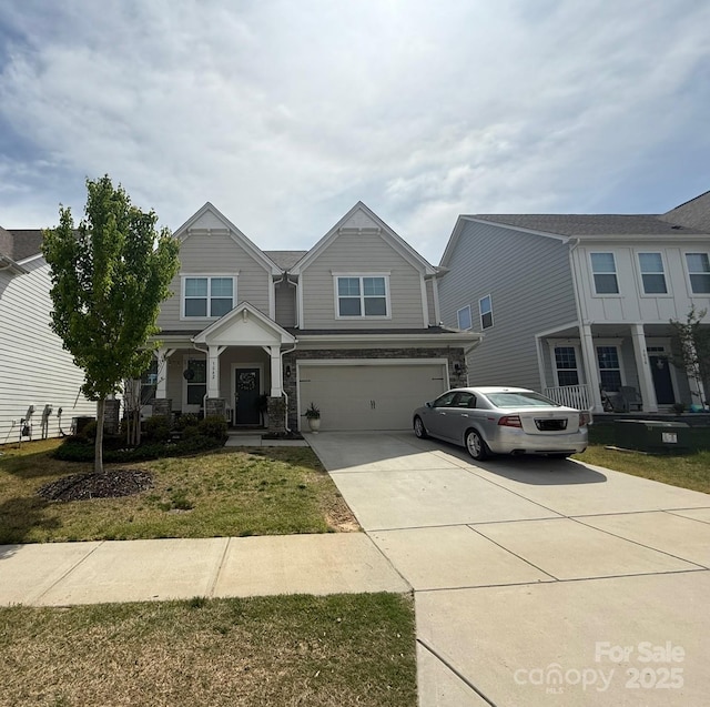 craftsman-style home with driveway, covered porch, and a garage