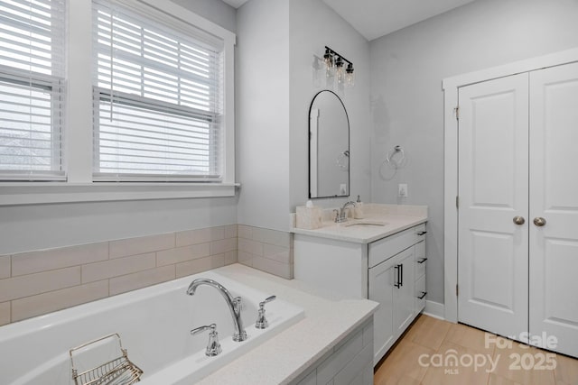 bathroom with a bath and vanity