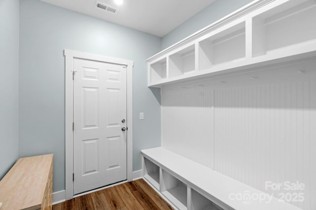 mudroom with visible vents, baseboards, and dark wood-style floors