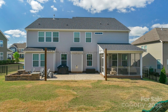 rear view of house with a patio area, a sunroom, fence, and a lawn