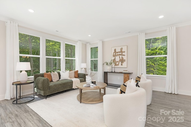 living room with visible vents, crown molding, wood finished floors, baseboards, and recessed lighting
