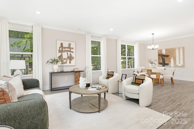 living room with a chandelier, recessed lighting, baseboards, wood finished floors, and ornamental molding