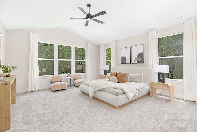 carpeted bedroom with multiple windows, a ceiling fan, vaulted ceiling, and visible vents