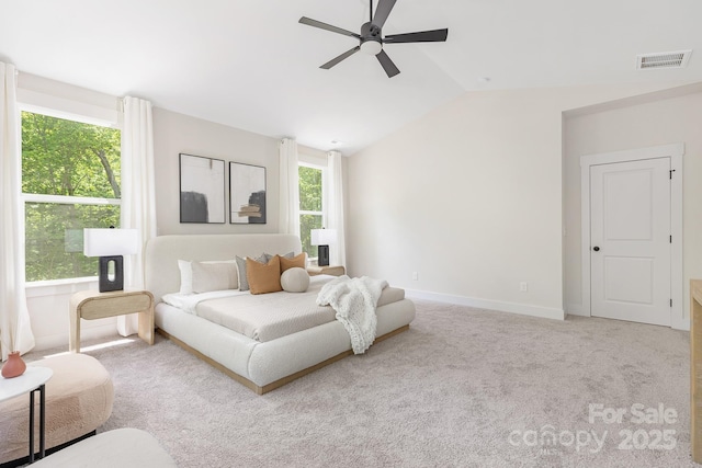 carpeted bedroom with visible vents, a ceiling fan, baseboards, and lofted ceiling