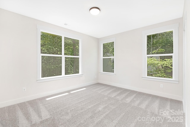 unfurnished room featuring carpet floors, baseboards, and visible vents