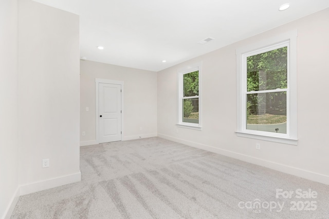 carpeted spare room with recessed lighting, baseboards, and visible vents