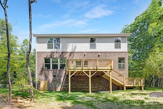 rear view of property featuring a wooden deck, stairway, and brick siding