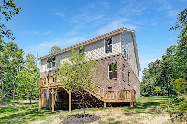 back of house with brick siding and a wooden deck