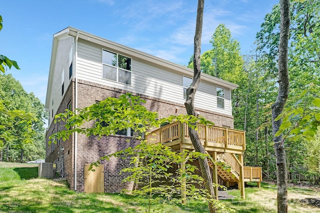 back of house with stairway, brick siding, and a deck