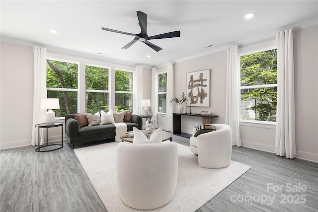 8937 Penstemons Dr, Charlotte, NC 28215 - living room featuring healthy amount of natural light, ceiling fan, crown molding, wood finished floors, and recessed lighting