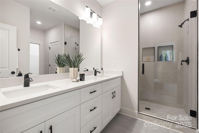 8937 Penstemons Dr, Charlotte, NC 28215 - full bathroom with a stall shower, double vanity, and recessed lighting
