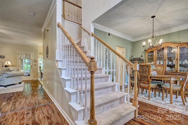 394 Runnymede Dr, Rock Hill, SC 29732 - stairway featuring visible vents, ornamental molding, a notable chandelier, and wood finished floors