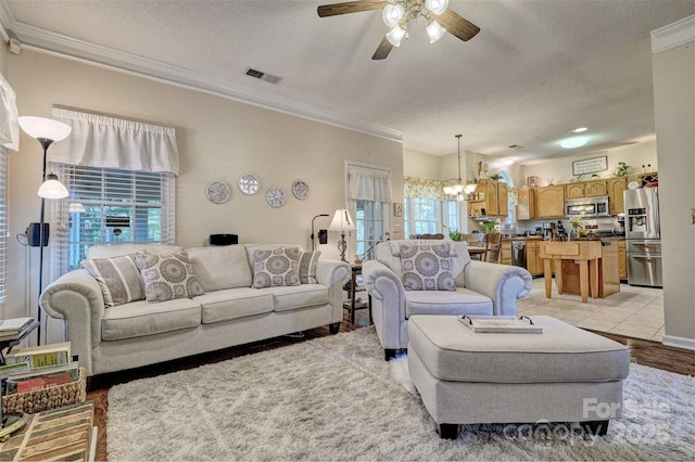 394 Runnymede Dr, Rock Hill, SC 29732 - living area featuring a textured ceiling, ceiling fan with notable chandelier, ornamental molding, and visible vents