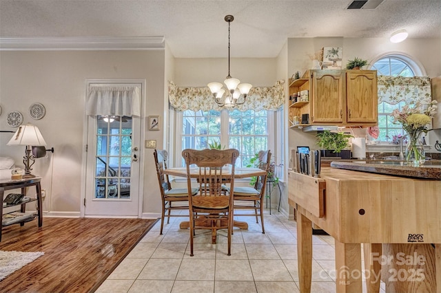 394 Runnymede Dr, Rock Hill, SC 29732 - dining room featuring baseboards, a textured ceiling, an inviting chandelier, and crown molding