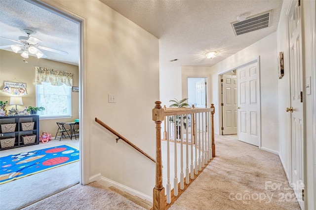 394 Runnymede Dr, Rock Hill, SC 29732 - hall featuring visible vents, an upstairs landing, carpet flooring, and a textured ceiling